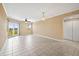 Bright living room features tile floors, neutral paint, sliding glass doors to balcony, and a contemporary light fixture at 4516 Seagull Dr # 408, New Port Richey, FL 34652