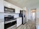 Modern kitchen with stainless steel appliances, granite countertops, and white cabinetry at 4817 Glenaire Ct, Tampa, FL 33624