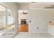 View from tiled sunroom into a living room featuring fireplace and wood floors at 4974 Harbor Woods Dr, Palm Harbor, FL 34683