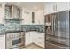 Kitchen featuring stainless steel appliances, including a refrigerator and a professional style range at 5541 Windward Way, New Port Richey, FL 34652