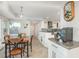 This eat-in kitchen features an island and decorative backsplash and is adjacent to the dining area at 5541 Windward Way, New Port Richey, FL 34652