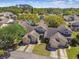 Aerial view of townhomes, lush landscaping, and a community swimming pool at 6518 Remus Dr, New Port Richey, FL 34653