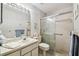 Cozy bathroom featuring a vanity, toilet, and glass door shower at 6518 Remus Dr, New Port Richey, FL 34653