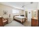 Bedroom with ceiling fan, window with blinds, and wood furniture at 6518 Remus Dr, New Port Richey, FL 34653