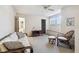 Bright bedroom features a futon, a wicker chair and ottoman, and neutral carpeting at 6518 Remus Dr, New Port Richey, FL 34653