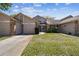 Exterior shot of home with a well-maintained lawn, attached garage, and charming two-story home at 6518 Remus Dr, New Port Richey, FL 34653