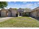 Street view of the property featuring a well-kept lawn, attached garage, and charming two-story home at 6518 Remus Dr, New Port Richey, FL 34653