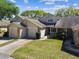 Charming townhome with a two-car garage, manicured lawn, and lush landscaping at 6518 Remus Dr, New Port Richey, FL 34653