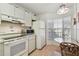 Bright eat-in kitchen with white appliances, bay window, and plenty of storage at 6518 Remus Dr, New Port Richey, FL 34653