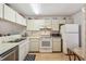 Practical kitchen with white cabinetry, stainless steel dishwasher, and modern appliances at 6518 Remus Dr, New Port Richey, FL 34653