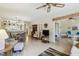 Comfortable living room featuring wood floors, a ceiling fan, and ample natural light at 6518 Remus Dr, New Port Richey, FL 34653