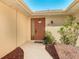 Home's front door is surrounded by beautiful landscaping at 6822 Eastbrook Dr, Spring Hill, FL 34606