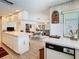 Kitchen with tiled countertops and flooring, opening to a living room with comfortable seating at 6822 Eastbrook Dr, Spring Hill, FL 34606