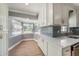 Bright kitchen featuring a bay window, white cabinets, and modern countertops at 6989 300 N Ave, Clearwater, FL 33761