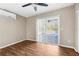 Bedroom featuring wood flooring, ceiling fan, and sliding glass doors to the pool at 7083 Devlin St, Weeki Wachee, FL 34613