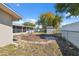 Large backyard featuring a shed, screened-in porch, and chain-link fence, offering ample space for outdoor activities at 7514 Bergamot Dr, Port Richey, FL 34668