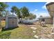 A spacious backyard with a storage shed, a white fence line, and ample yard space at 7514 Bergamot Dr, Port Richey, FL 34668