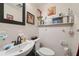 Functional bathroom with tile flooring and built in storage space above the sink and toilet at 7514 Bergamot Dr, Port Richey, FL 34668