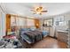 Bedroom with wood floors, a ceiling fan and neutral paint at 7514 Bergamot Dr, Port Richey, FL 34668