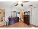 Bedroom featuring wood flooring, dark wood furniture, and access to the bathroom and closet at 7514 Bergamot Dr, Port Richey, FL 34668