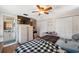 Bedroom featuring wood floors, a ceiling fan, and an adjacent bathroom at 7514 Bergamot Dr, Port Richey, FL 34668