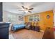 Bedroom with light wood flooring, a ceiling fan, and two windows for natural light at 7514 Bergamot Dr, Port Richey, FL 34668