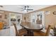 Bright eat-in dining area with tile floors and access to the living room and backyard at 7514 Bergamot Dr, Port Richey, FL 34668