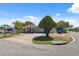 Charming one-story home featuring a well-maintained lawn and a circular driveway at 7514 Bergamot Dr, Port Richey, FL 34668