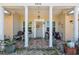Inviting front porch featuring decorative columns and neutral tile at 7514 Bergamot Dr, Port Richey, FL 34668