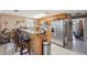 Traditional kitchen with stainless steel appliances, tile floors, and a breakfast bar with granite countertops at 7514 Bergamot Dr, Port Richey, FL 34668