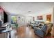 Bright living room featuring hardwood floors, a large window and a comfortable seating area at 7514 Bergamot Dr, Port Richey, FL 34668