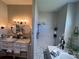 Bathroom featuring a shower, dual sinks, decor, and vanity with lighting at 7748 Leighton Cir, New Port Richey, FL 34654