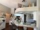 Kitchen area featuring an island with barstool seating, stainless appliances, and a well-organized pantry at 7748 Leighton Cir, New Port Richey, FL 34654