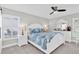 Serene bedroom with coastal decor, plantation shutters, and a ceiling fan at 8231 Palencia Dr, Port Richey, FL 34668