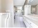 Bright bathroom featuring a walk in tub and double sink vanity offering accessibility and classic design elements at 9131 Rhett Ln, Weeki Wachee, FL 34613