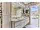Spacious bathroom boasting a double sink vanity, access to the pool area, and bright overhead lighting at 9131 Rhett Ln, Weeki Wachee, FL 34613