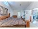 Bedroom with a large wooden bed, leading to a sunroom and en-suite bathroom, offering a private retreat at 9131 Rhett Ln, Weeki Wachee, FL 34613