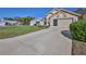Exterior view of a one-story home featuring an attached two-car garage and mature landscaping at 9131 Rhett Ln, Weeki Wachee, FL 34613