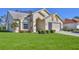 A one-story home featuring an attached two-car garage, a well-manicured lawn, and tidy landscaping at 9131 Rhett Ln, Weeki Wachee, FL 34613