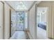 Bright foyer with tile flooring, a decorative rug, and a view into the bedroom at 9131 Rhett Ln, Weeki Wachee, FL 34613