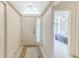 Bright entryway with tile flooring and a view into the bedroom with a ceiling fan at 9131 Rhett Ln, Weeki Wachee, FL 34613