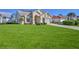 Inviting front exterior of a single-story home with a lush green lawn and well-maintained landscaping at 9131 Rhett Ln, Weeki Wachee, FL 34613