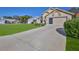 Exterior of a single-story home with a well-manicured lawn and a two-car garage at 9131 Rhett Ln, Weeki Wachee, FL 34613