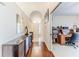 Inviting hallway featuring dark wood floors and a view of the front door with adjacent office space at 9131 Rhett Ln, Weeki Wachee, FL 34613