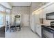 Bright eat-in kitchen featuring white cabinetry, stainless steel appliances, and lots of natural light at 9131 Rhett Ln, Weeki Wachee, FL 34613