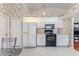 Well-lit kitchen featuring modern appliances, white cabinets, and tiled floors at 9131 Rhett Ln, Weeki Wachee, FL 34613