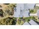 An aerial view of the home's roof, landscaping, and surrounding greenery at 9144 Bassett Ln, New Port Richey, FL 34655