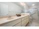 Bathroom featuring double sinks, updated vanity, and glass shower at 9144 Bassett Ln, New Port Richey, FL 34655