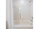 Bathtub with a shower curtain, tiled walls, and shower head at 9144 Bassett Ln, New Port Richey, FL 34655