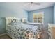 Charming bedroom with two beds, blue walls, and a bright window at 9144 Bassett Ln, New Port Richey, FL 34655